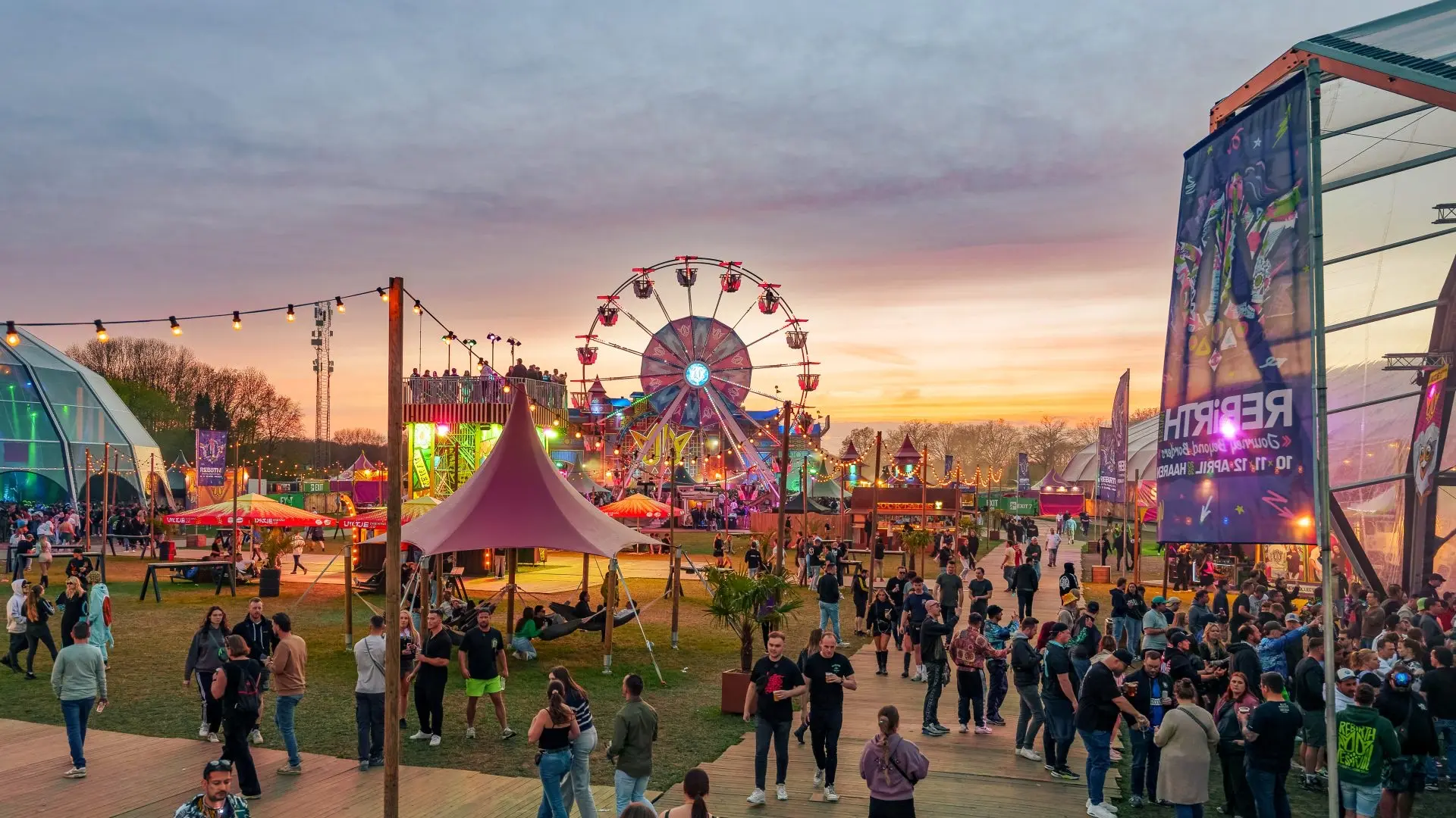 Fans exploring the REBiRTH festival grounds at sunset