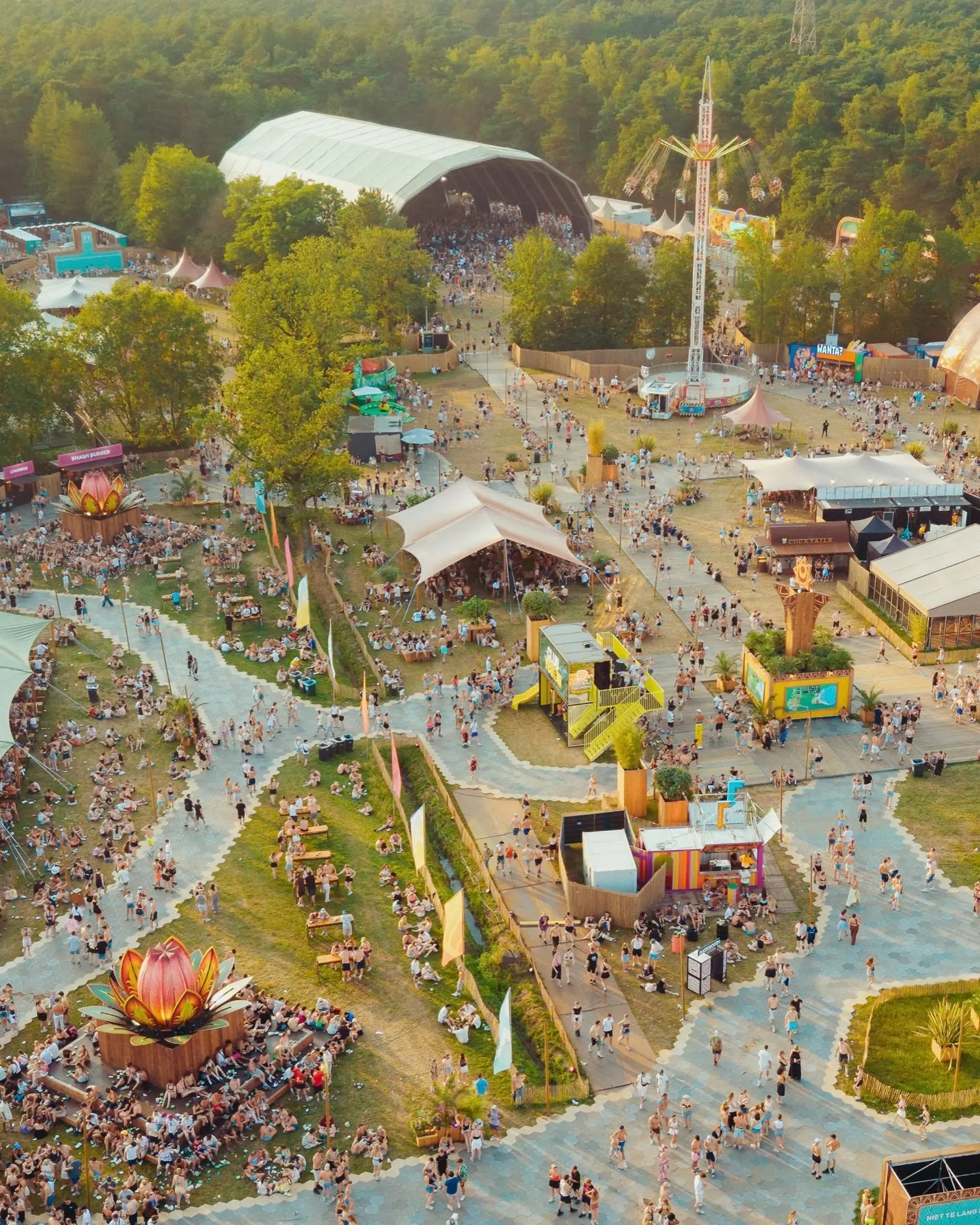 Aerial view of the Sunrise Festival grounds, with the main tent and paths through the woods